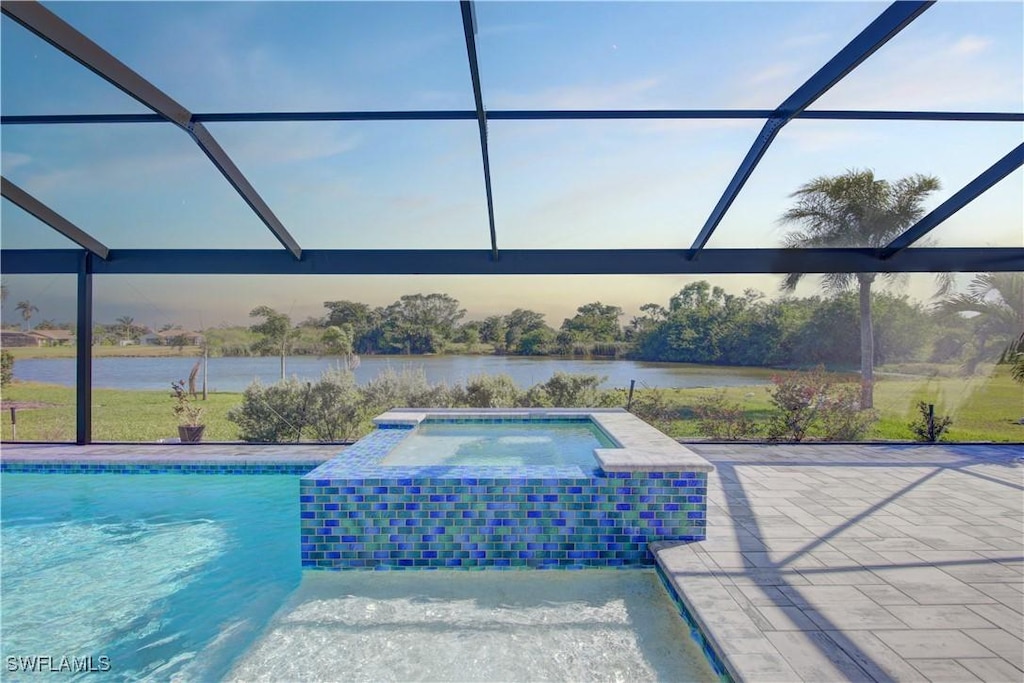 view of swimming pool featuring an in ground hot tub, a patio, a water view, and a lanai