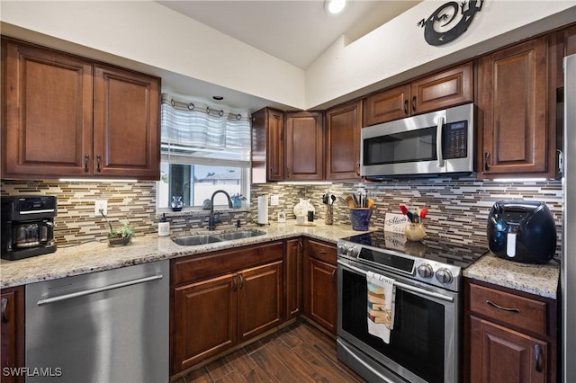 kitchen with decorative backsplash, dark hardwood / wood-style floors, sink, and stainless steel appliances