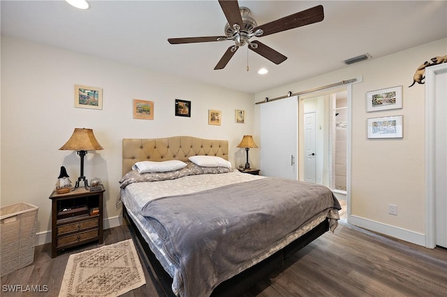 bedroom featuring ceiling fan, dark hardwood / wood-style flooring, and connected bathroom