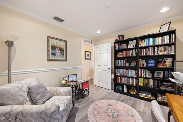 sitting room featuring light wood-type flooring and ornamental molding