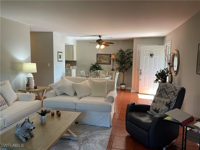 living room featuring ceiling fan and tile patterned floors