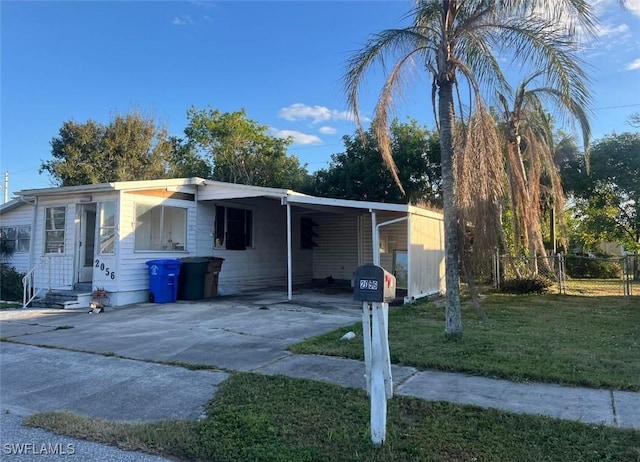 single story home featuring a front yard and a carport