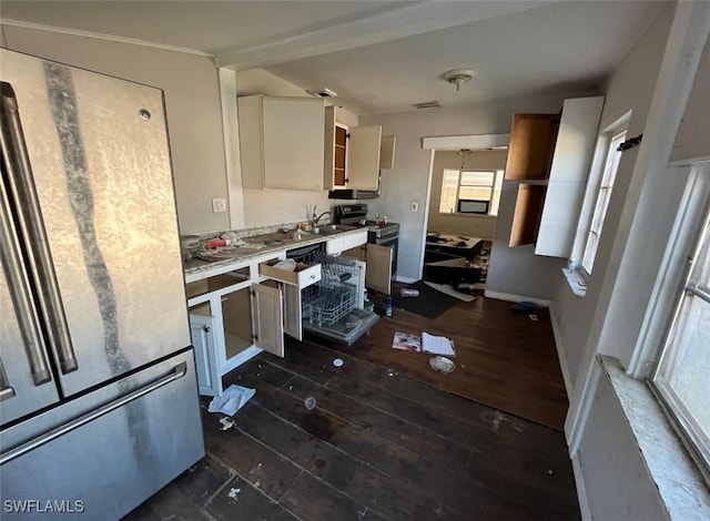 kitchen with appliances with stainless steel finishes, white cabinetry, and sink