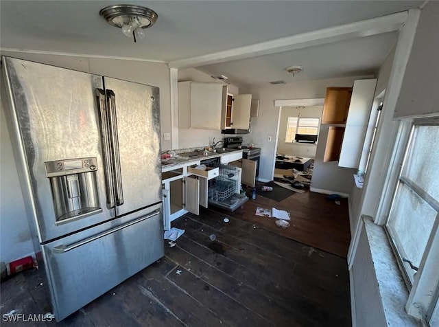 kitchen with white cabinets, appliances with stainless steel finishes, dark hardwood / wood-style floors, and vaulted ceiling