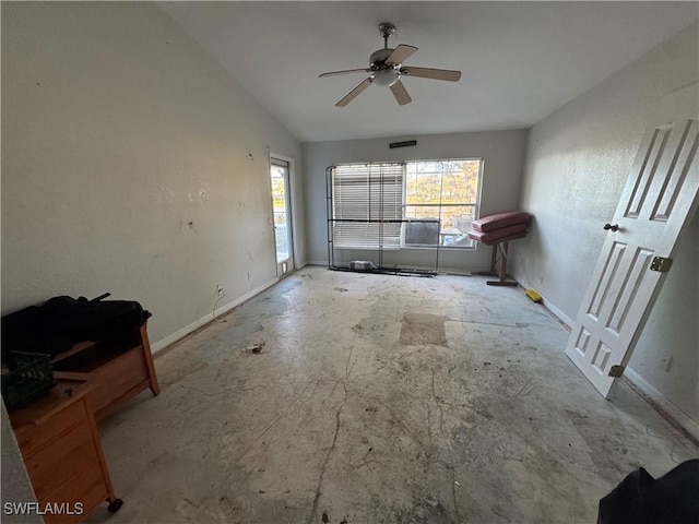 unfurnished living room featuring lofted ceiling, a healthy amount of sunlight, and ceiling fan