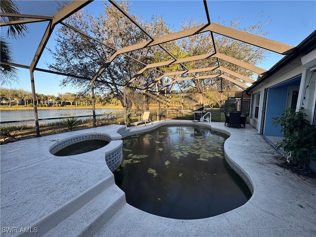 view of swimming pool with an in ground hot tub, a water view, glass enclosure, and a patio area