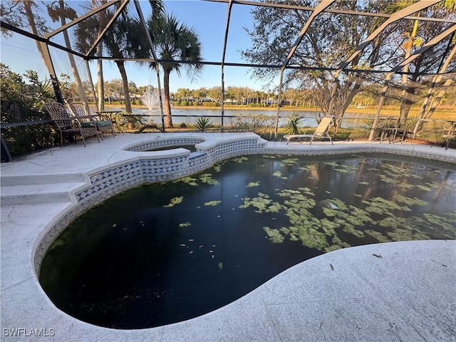 view of pool featuring a lanai, a patio, a water view, and an in ground hot tub