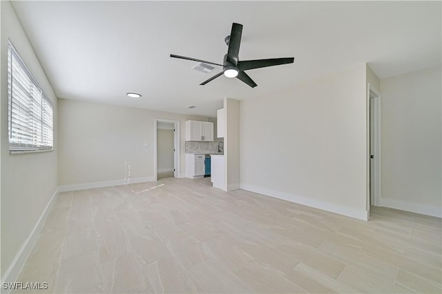 unfurnished living room with ceiling fan