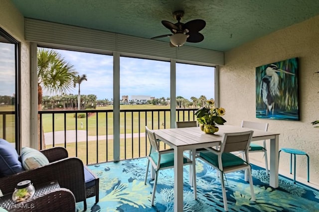 sunroom featuring ceiling fan