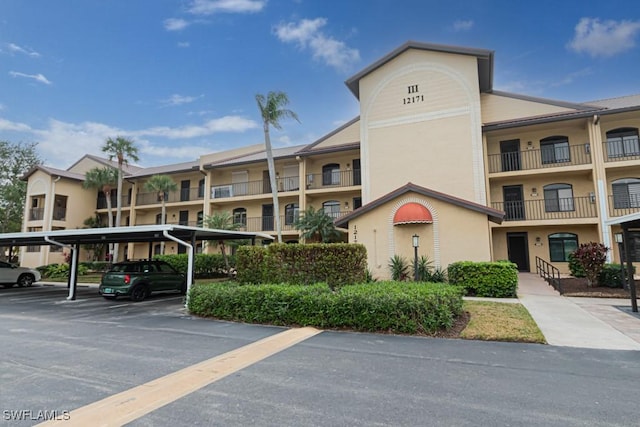 view of property featuring covered parking