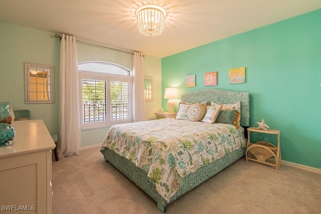 carpeted bedroom featuring a notable chandelier