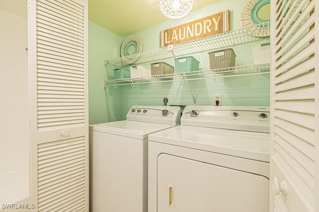 clothes washing area featuring separate washer and dryer