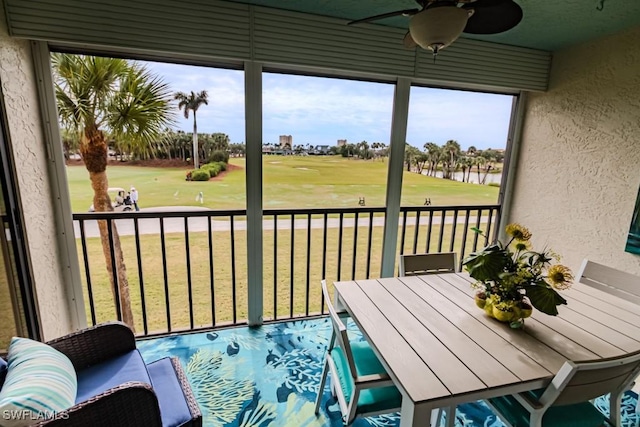 sunroom featuring ceiling fan