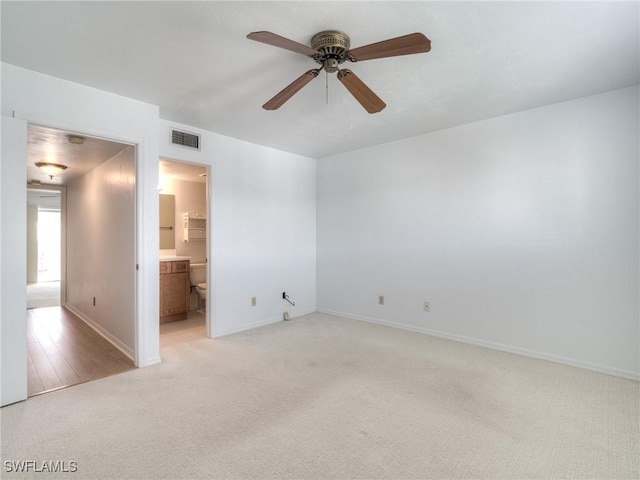 unfurnished room with light colored carpet and ceiling fan