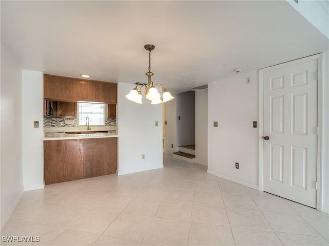 interior space featuring light tile patterned floors and a chandelier