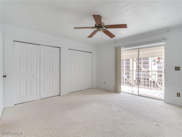 unfurnished bedroom with light carpet, access to exterior, multiple closets, and ceiling fan