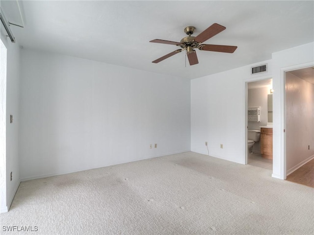 carpeted empty room featuring ceiling fan