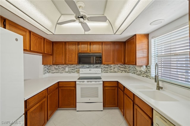 kitchen featuring light tile patterned floors, sink, white appliances, ceiling fan, and decorative backsplash