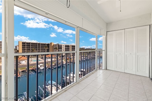 balcony with a water view and ceiling fan