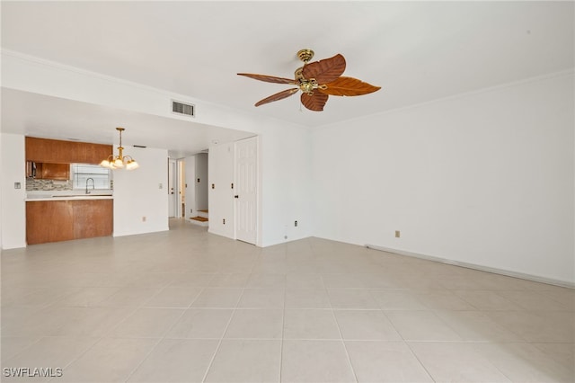 unfurnished living room featuring crown molding, sink, and ceiling fan with notable chandelier