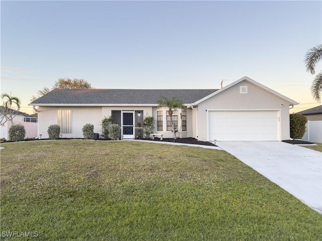 ranch-style home with a lawn and a garage