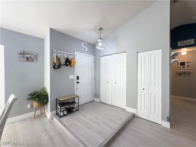 entryway with hardwood / wood-style flooring and lofted ceiling