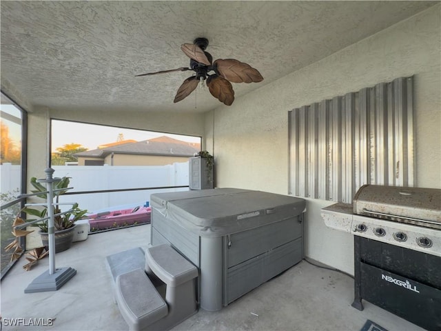 view of patio with grilling area, ceiling fan, and a hot tub