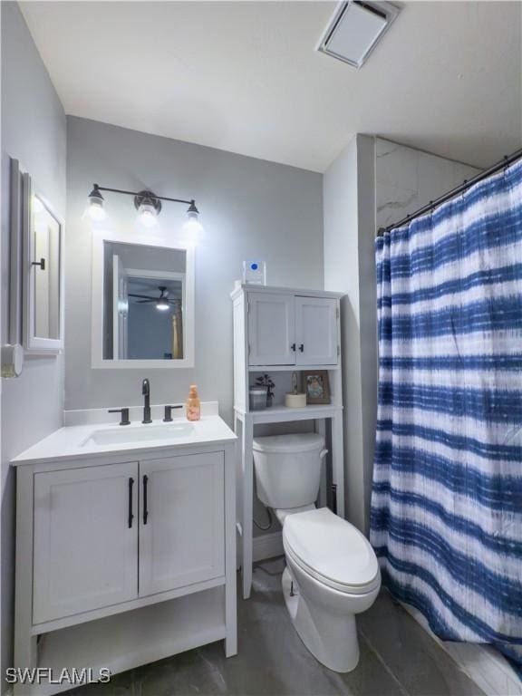 bathroom featuring curtained shower, vanity, and toilet