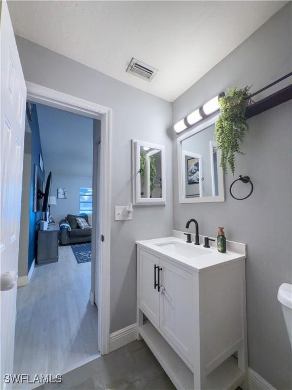 bathroom featuring vanity and toilet