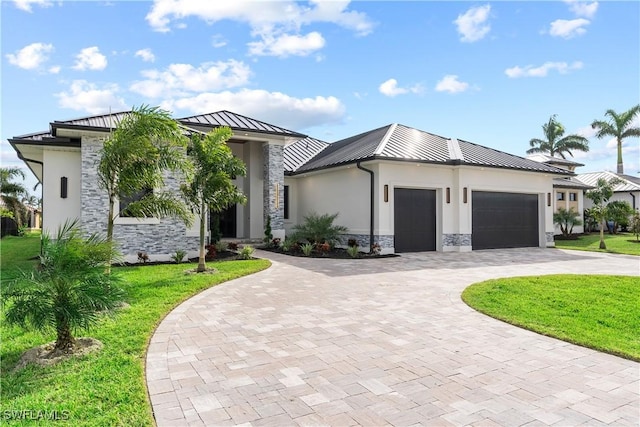 view of front of home with a garage and a front lawn