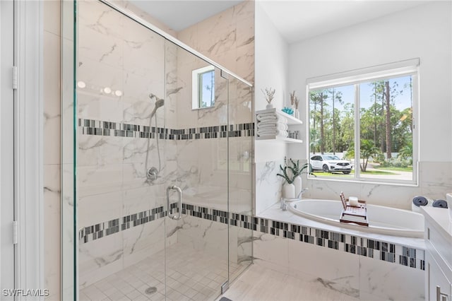 bathroom featuring separate shower and tub