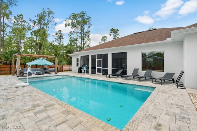 view of swimming pool featuring a pergola, a patio, and a sunroom