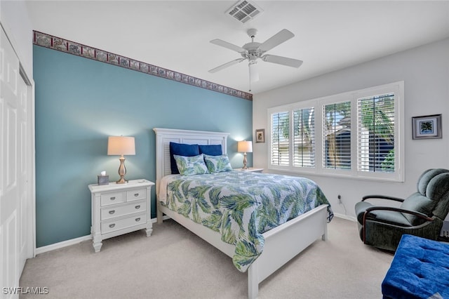 bedroom featuring ceiling fan, a closet, and light carpet