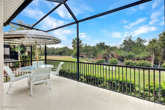 view of patio / terrace featuring glass enclosure