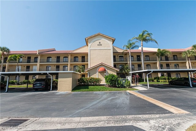 view of building exterior featuring covered parking