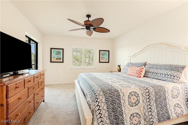 bedroom featuring ceiling fan and light carpet