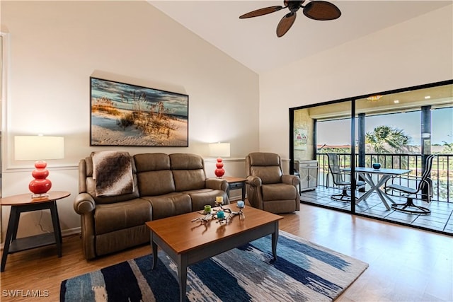 living room featuring wood-type flooring, high vaulted ceiling, and ceiling fan