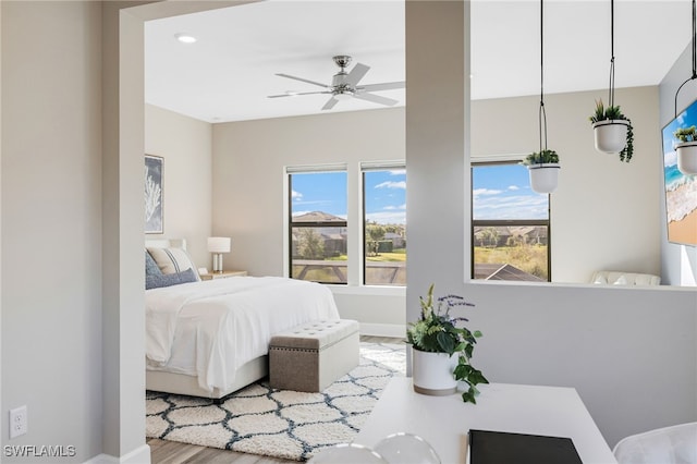 bedroom with ceiling fan and hardwood / wood-style floors