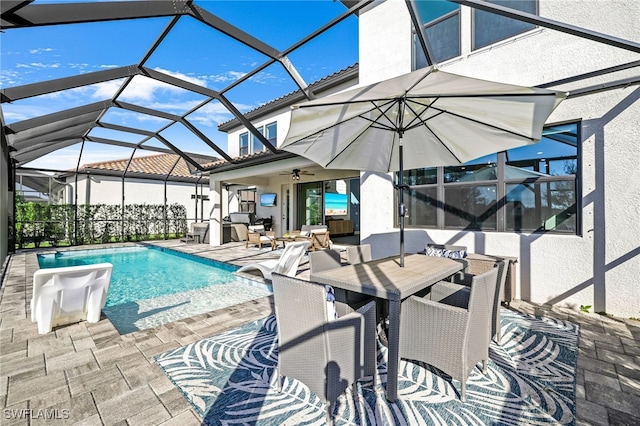 view of swimming pool featuring a lanai, a patio area, and ceiling fan