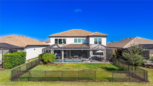 back of house with a lawn, glass enclosure, a fenced in pool, and a balcony