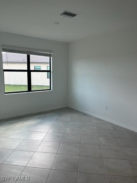 unfurnished room with light tile patterned floors