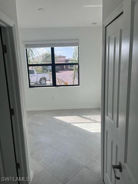 spare room featuring light tile patterned floors