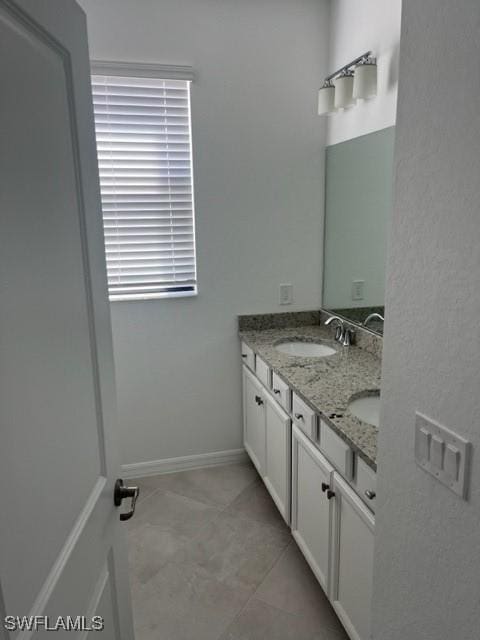 bathroom featuring tile patterned flooring and vanity