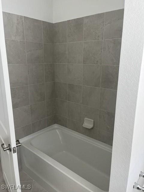 bathroom with tile patterned flooring and tiled shower / bath combo