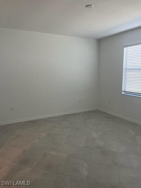 spare room featuring tile patterned flooring