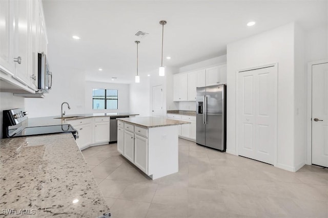 kitchen with a peninsula, visible vents, appliances with stainless steel finishes, and white cabinets