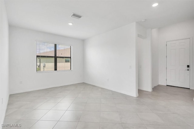 unfurnished room with light tile patterned floors, baseboards, visible vents, and recessed lighting
