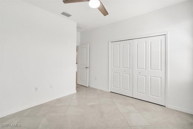 unfurnished bedroom with baseboards, a ceiling fan, visible vents, and a closet