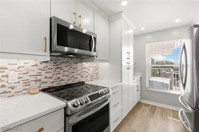 kitchen with tasteful backsplash, white cabinetry, stainless steel appliances, and light stone counters