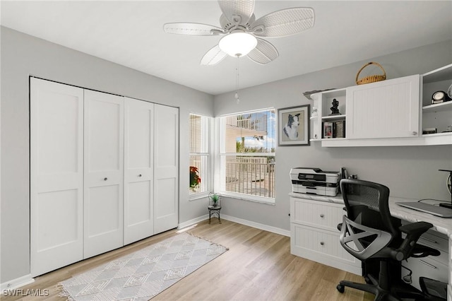 home office featuring ceiling fan and light hardwood / wood-style floors